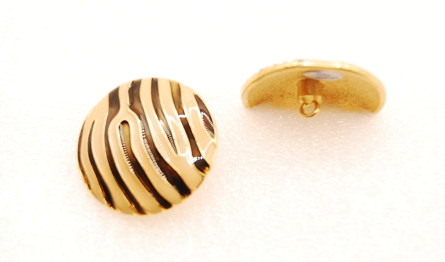 Striped gold button
